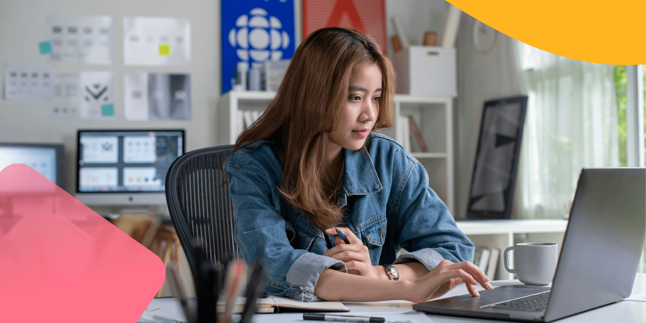 A woman is sitting at her laptop setting gender equality goals.